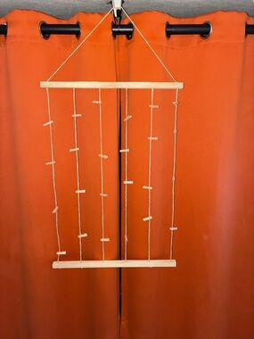 Source Unknown Natural Wood and Twine Hanging Photo Display with Orange Backdrop